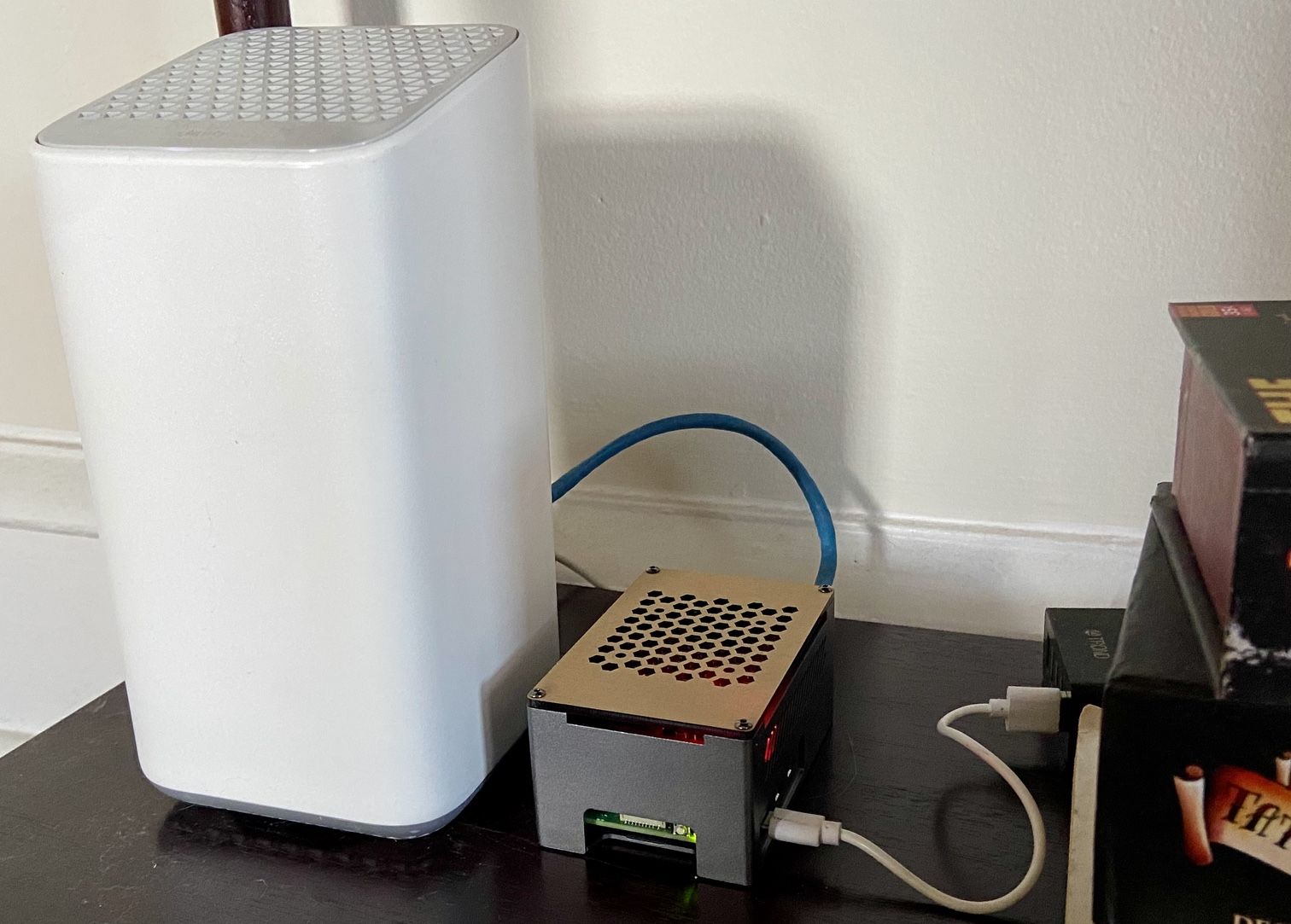 Little Raspberry Pi box sitting next to the Comcast gateway